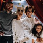 Family dressed up for a fun home theater activity, showcasing creativity and bonding.